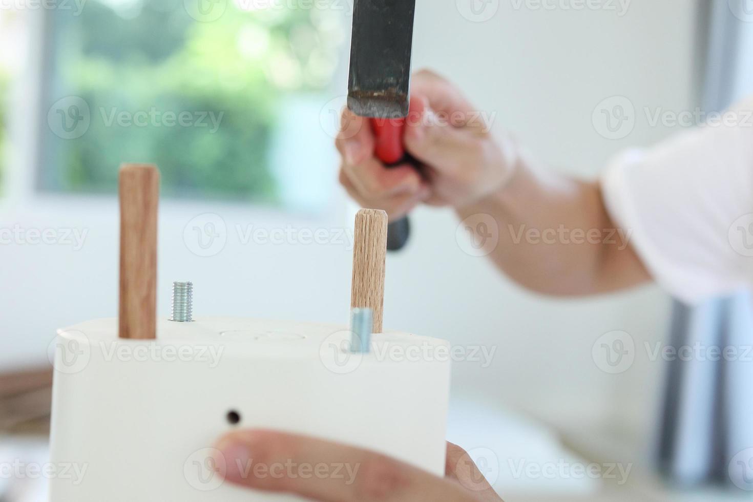 Man assembling furniture at home photo