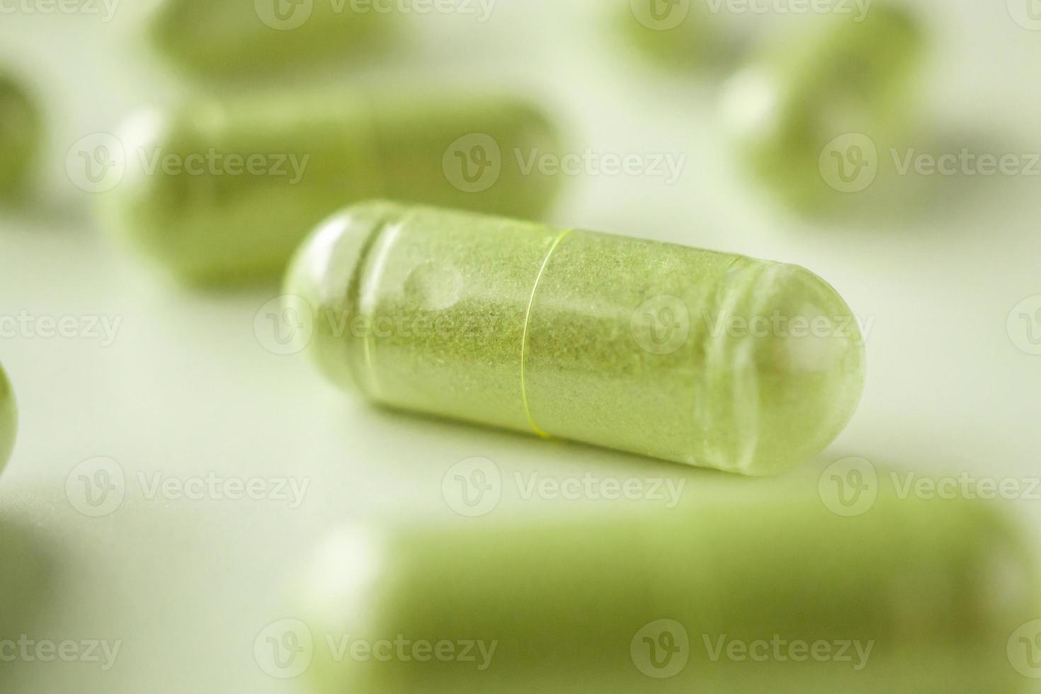 Herbal medicine capsules on white background photo