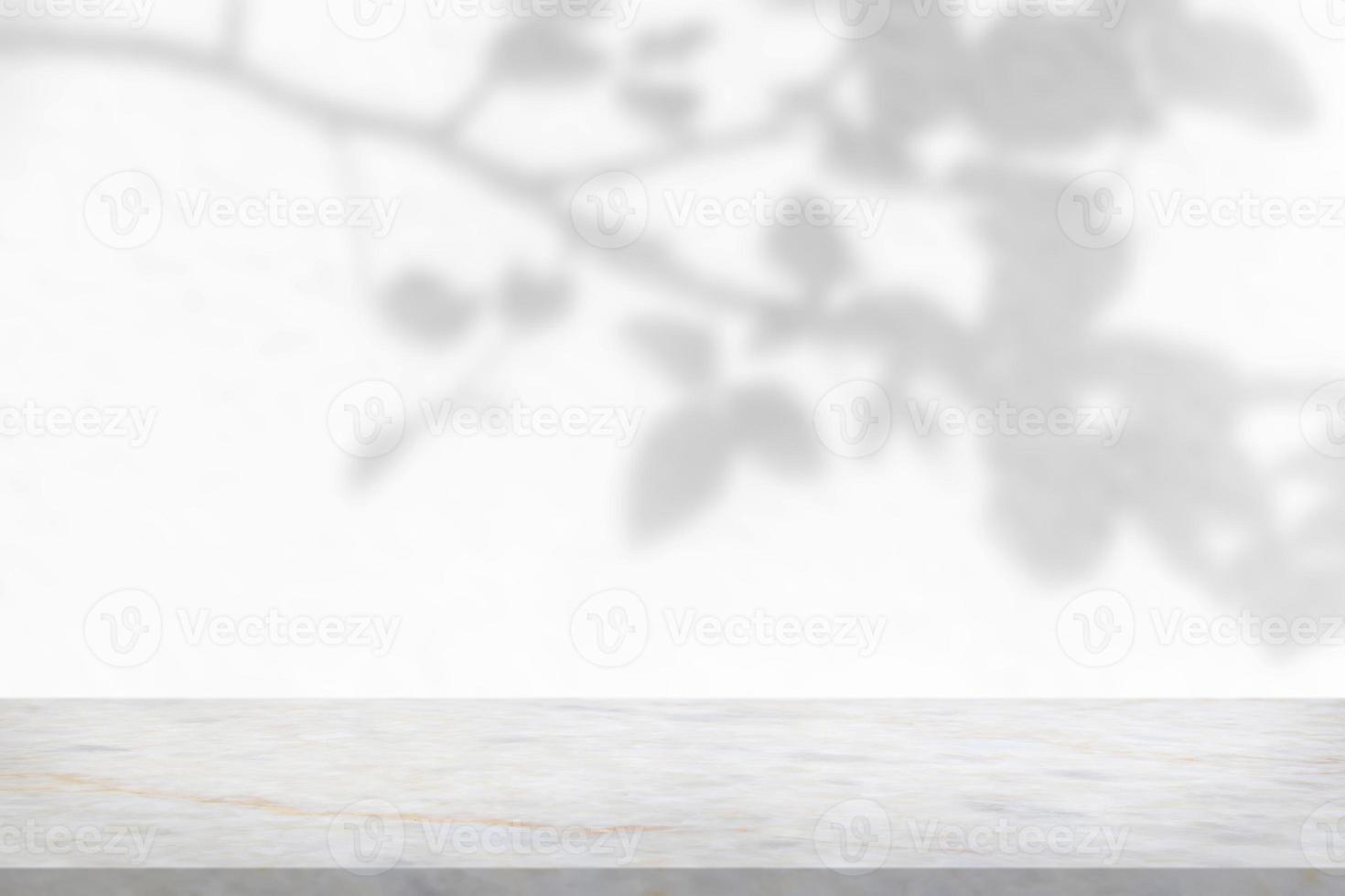 Marble table with tree shadow drop on white wall background for mockup product display photo