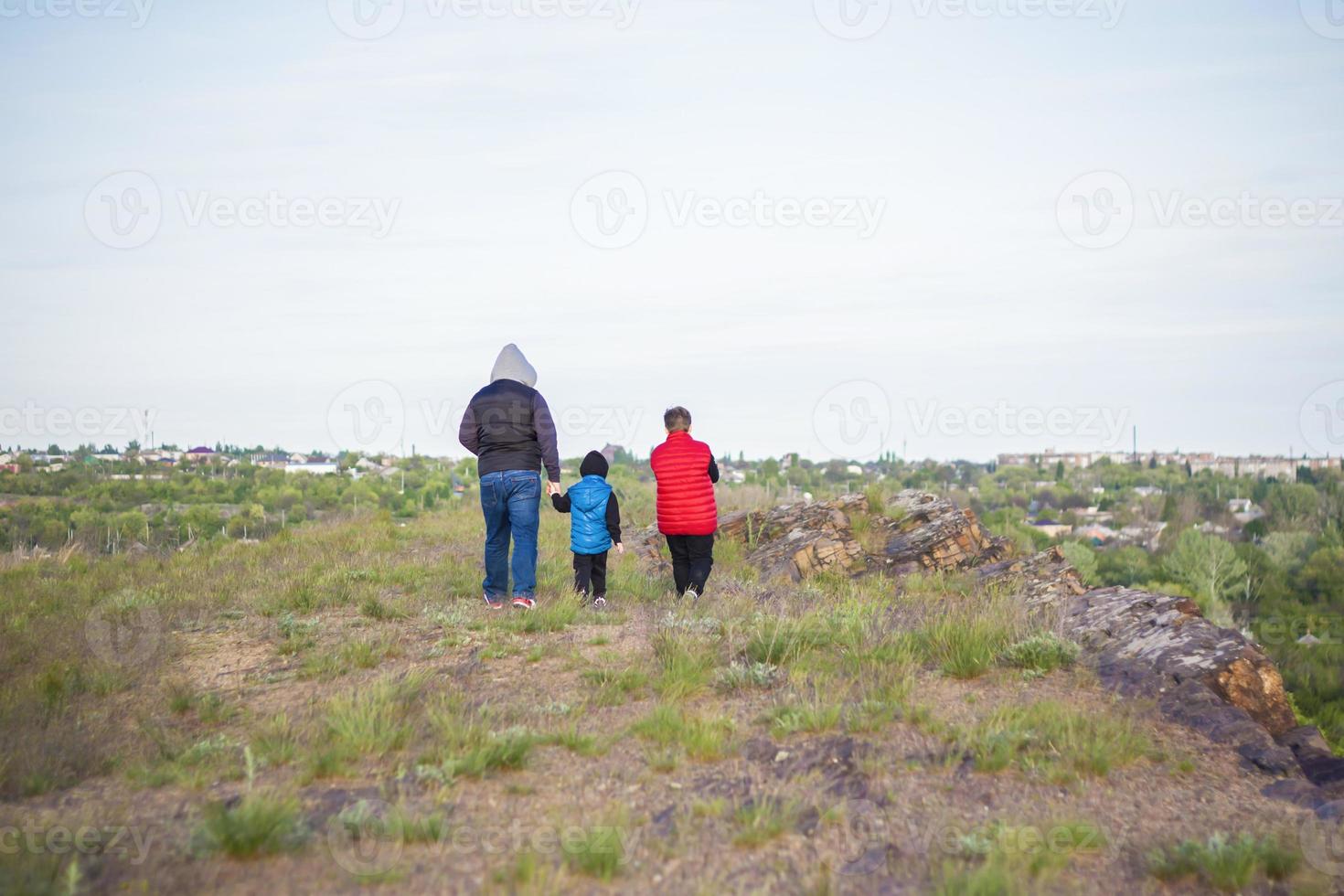 A man and children are standing on a rock and watching what is happening below. panoramic view from above. Russia, Rostov region, skelevataya skala, the 7th wonder of the Don world. photo