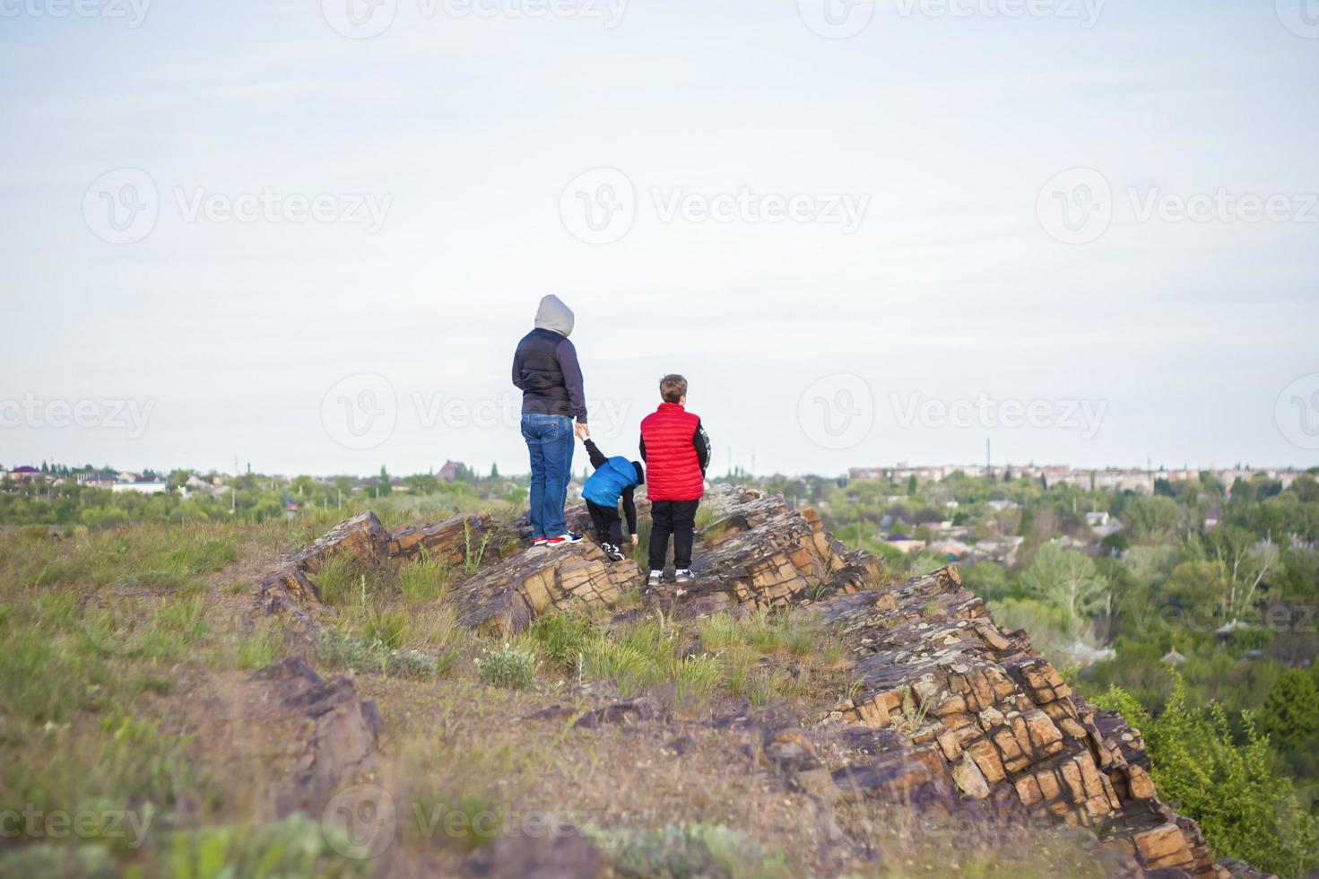 A man and children are standing on a rock and watching what is happening below. panoramic view from above. Russia, Rostov region, skelevataya skala, the 7th wonder of the Don world. photo