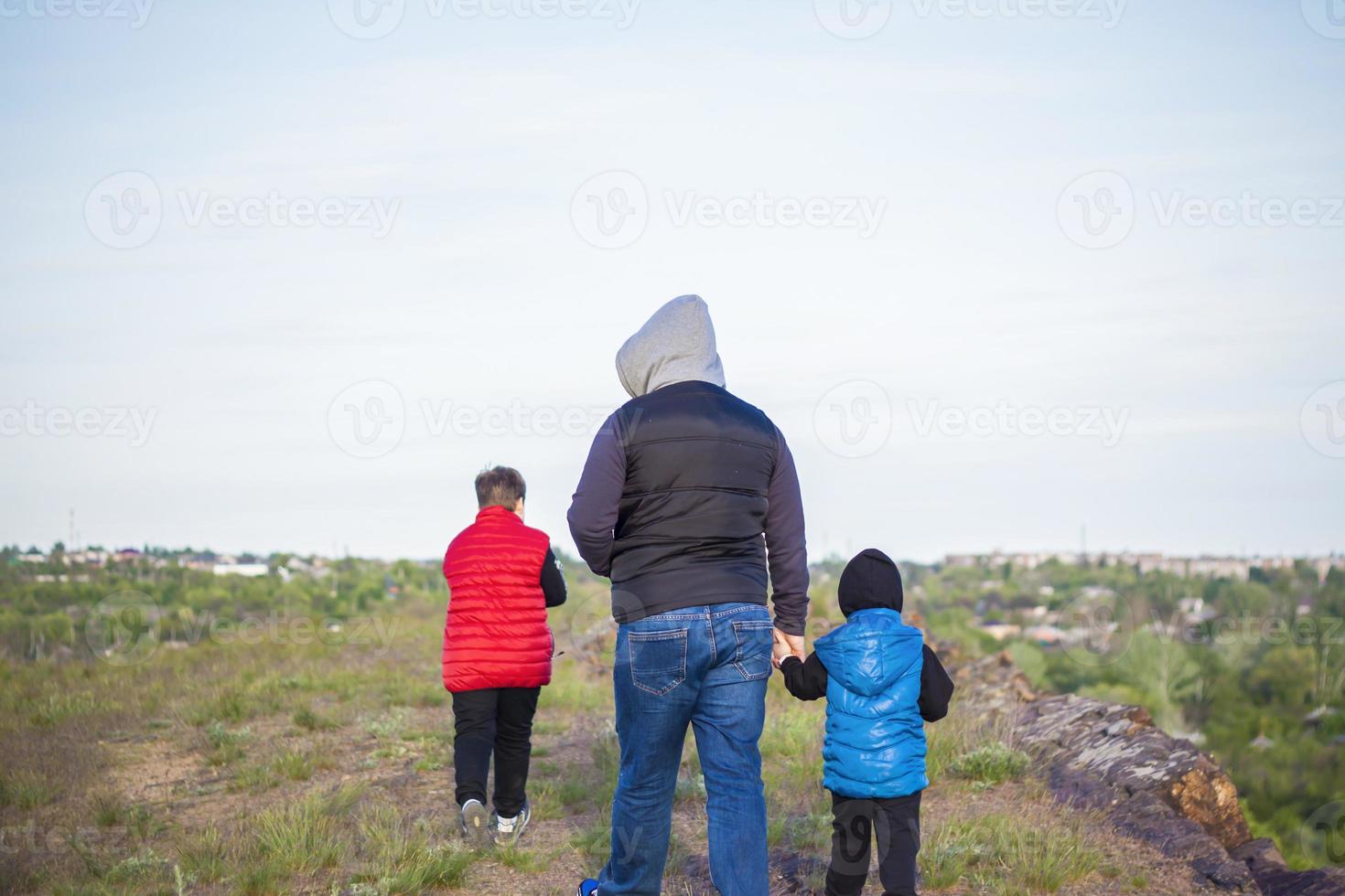 A man and children are standing on a rock and watching what is happening below. panoramic view from above. Russia, Rostov region, skelevataya skala, the 7th wonder of the Don world. photo