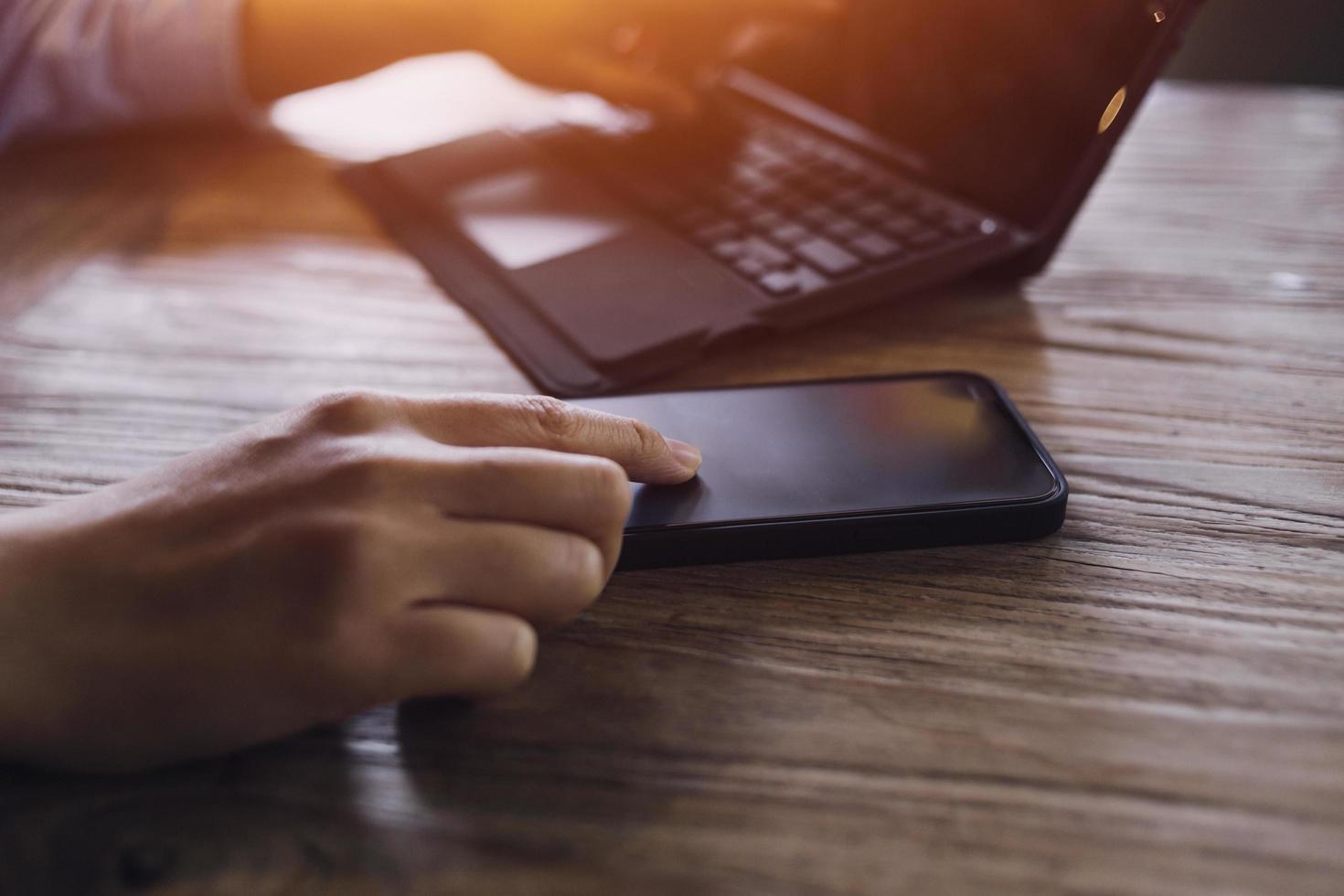 businesswoman hand working with laptop computer, tablet and smart phone in modern office with virtual icon diagram at modernoffice in morning light photo
