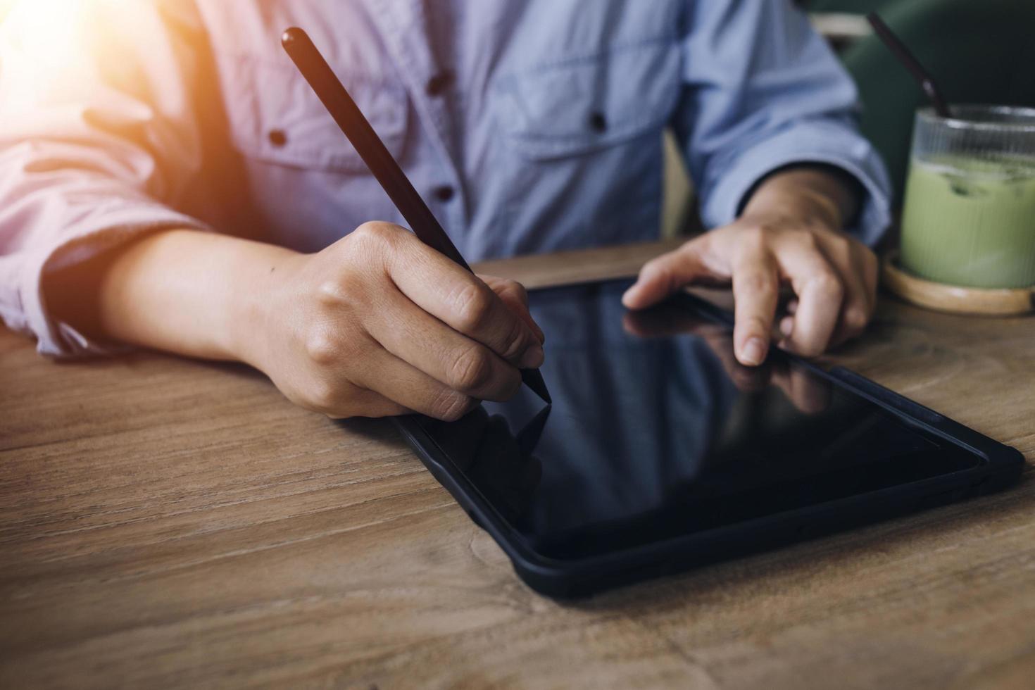 businesswoman hand working with laptop computer, tablet and smart phone in modern office with virtual icon diagram at modernoffice in morning light photo