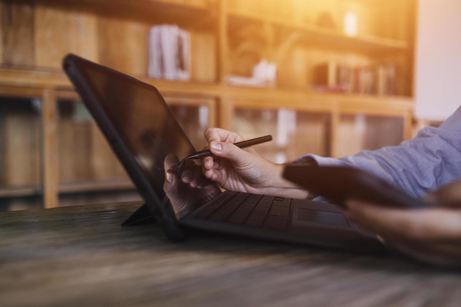 businesswoman hand working with laptop computer, tablet and smart phone in modern office with virtual icon diagram at modernoffice in morning light photo