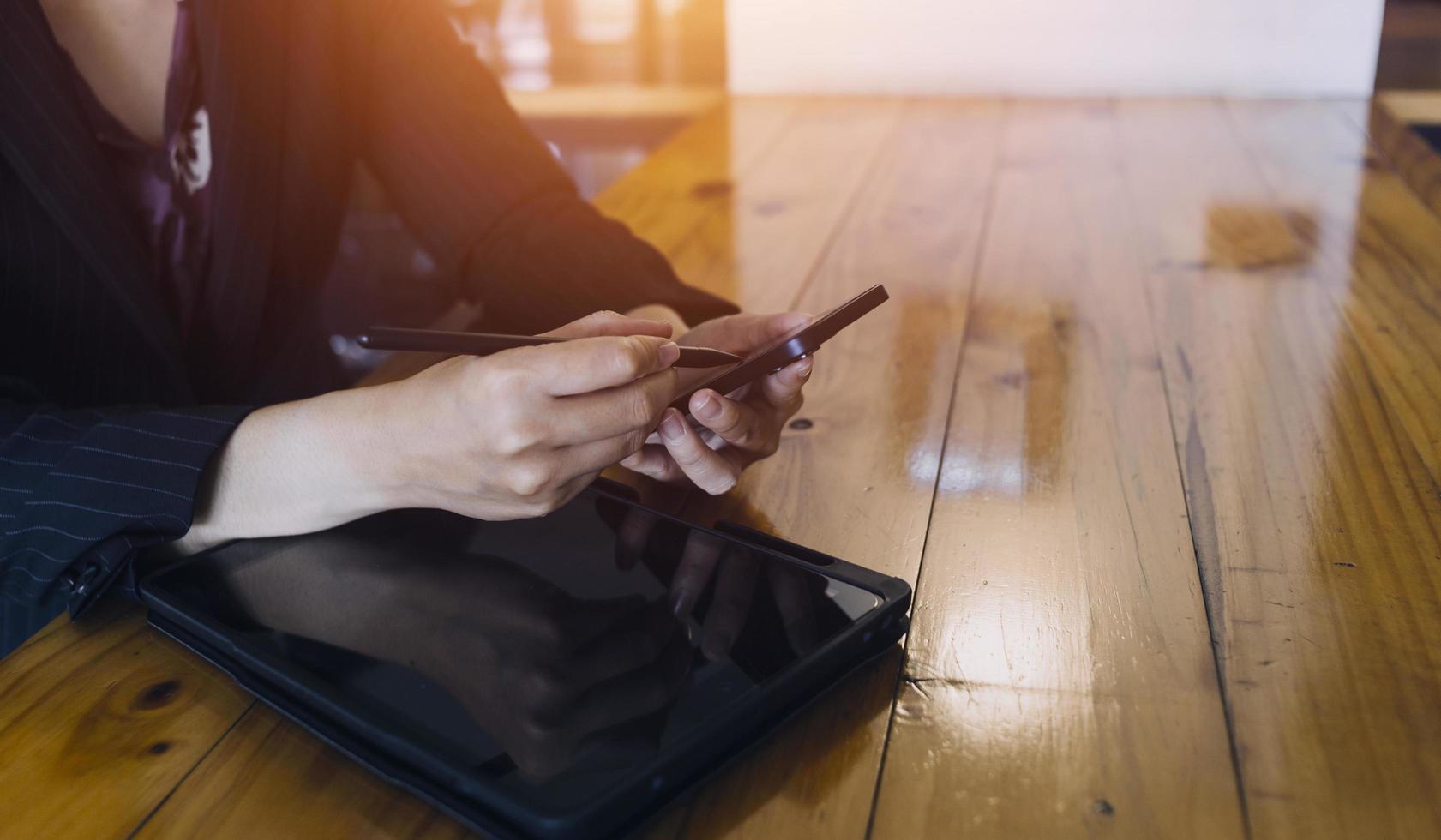 businesswoman hand working with laptop computer, tablet and smart phone in modern office with virtual icon diagram at modernoffice in morning light photo