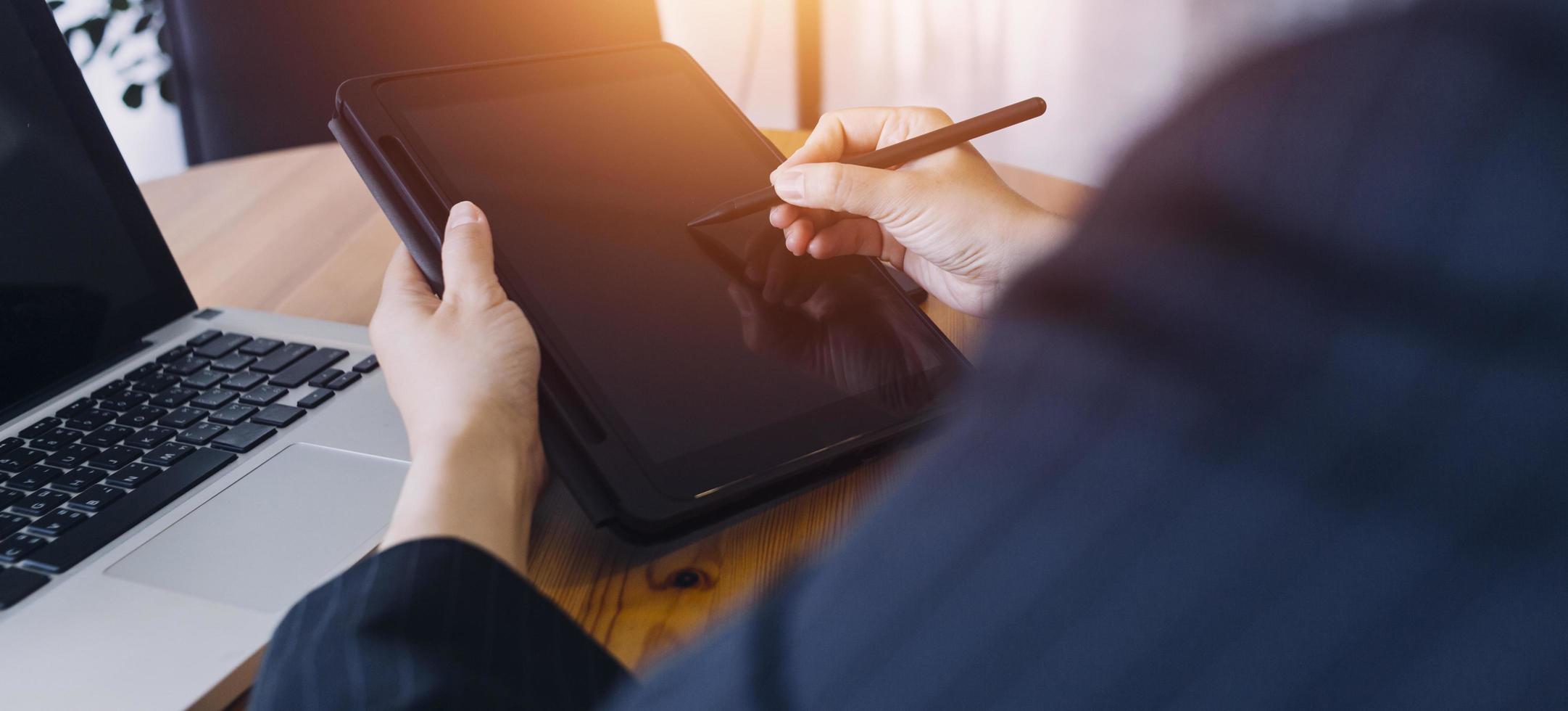 businesswoman hand working with laptop computer, tablet and smart phone in modern office with virtual icon diagram at modernoffice in morning light photo