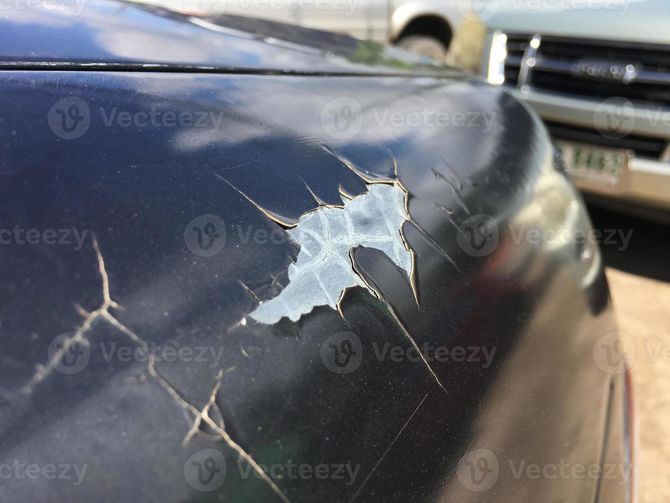The paint sheet on the outside surface of the car is cracked into various shapes according to the condition and time of use of the car photo