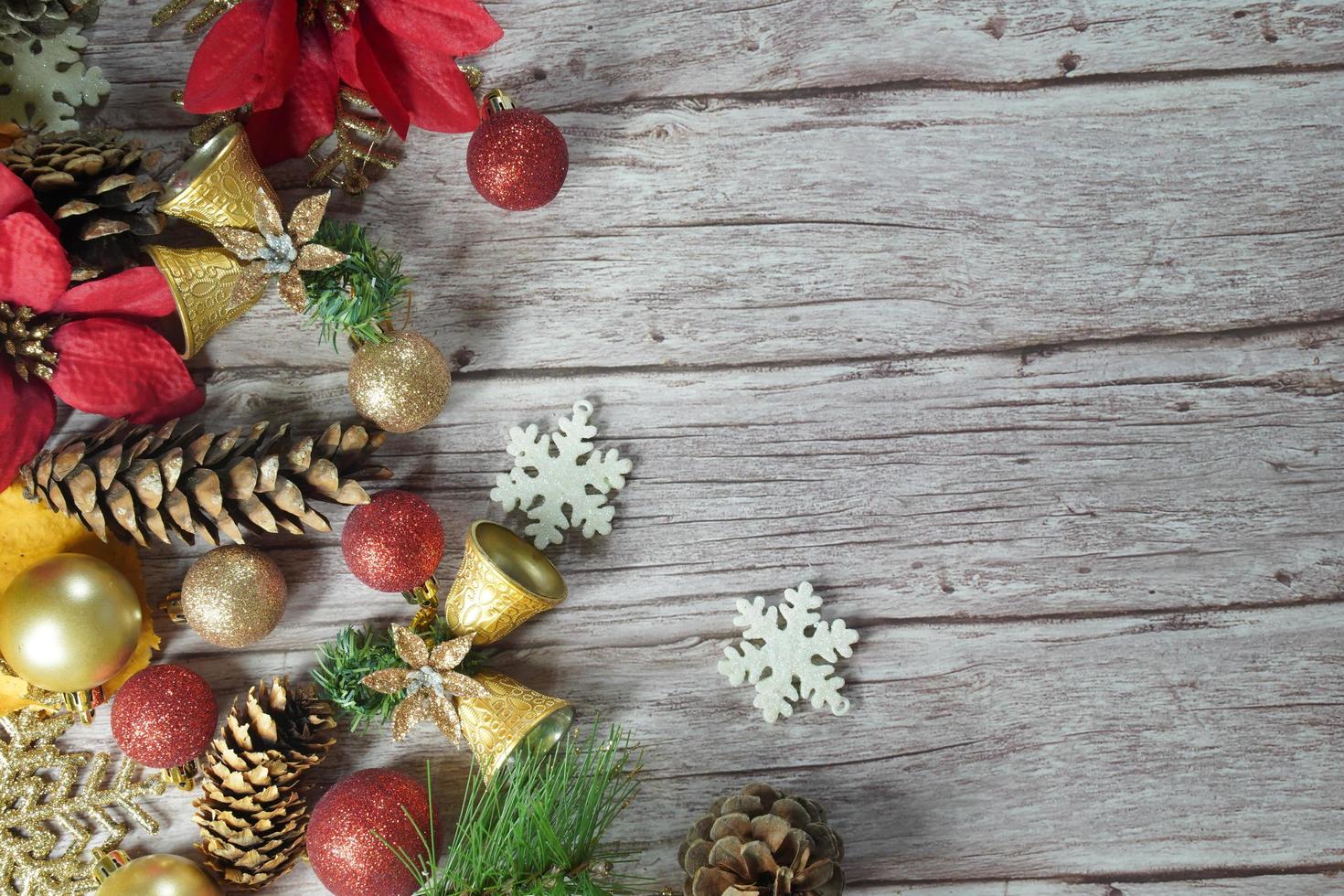 Red and gold Christmas ornament corner border banner. Above view on a rustic wood background. photo