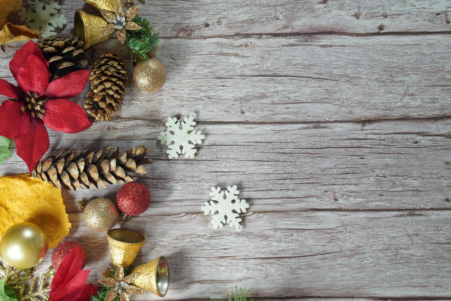 Red and gold Christmas ornament corner border banner. Above view on a rustic wood background. photo