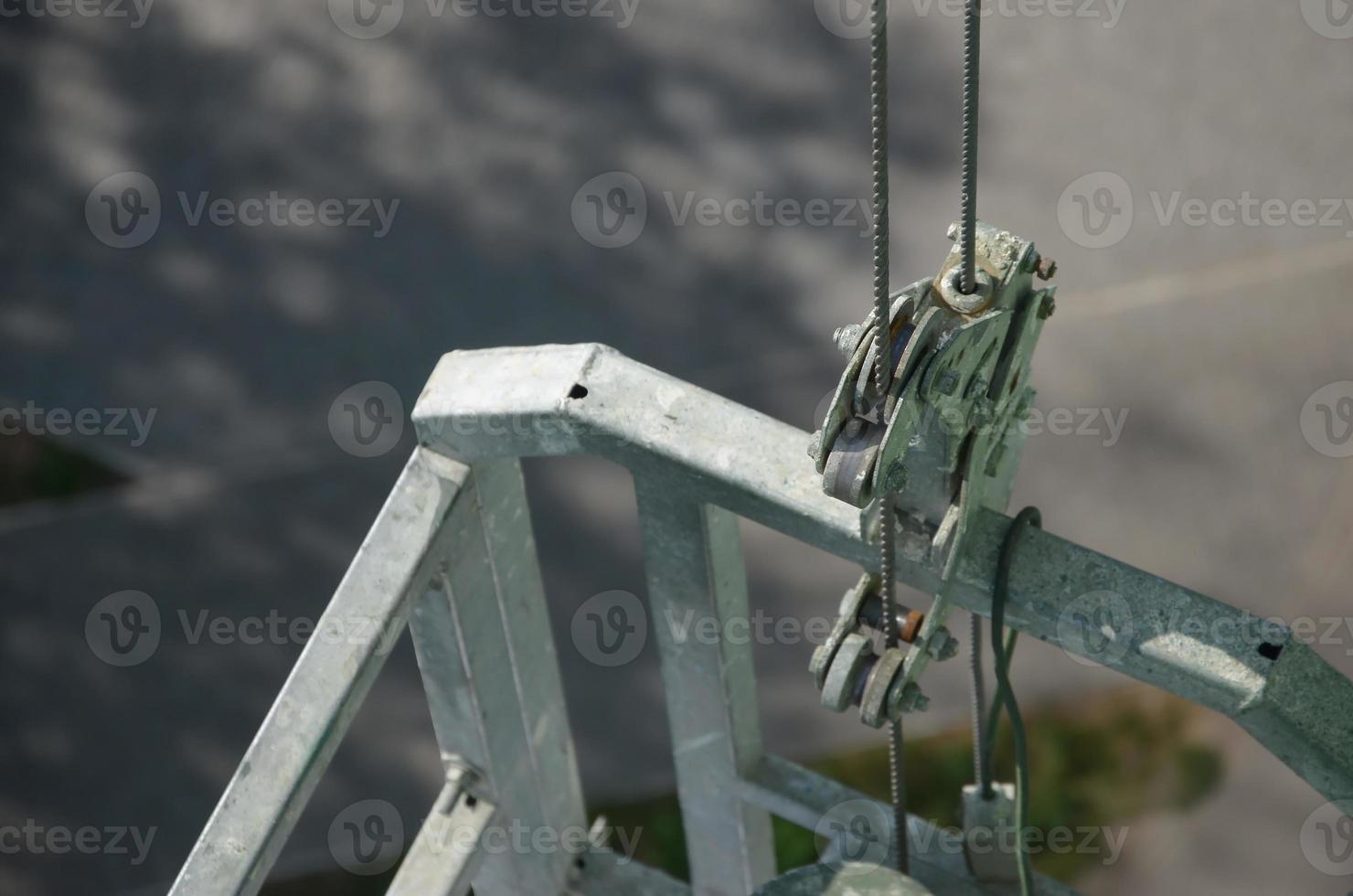 Safety lock as part of suspended wire rope platform for facade works on high multistorey buildings. Safety lock for securing the working platform from falling in control malfunction photo