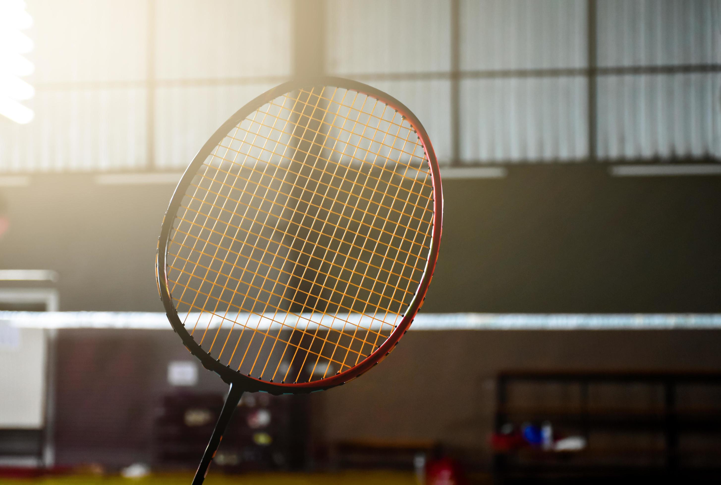 Closeup badminton racket in front of the net before serving it to