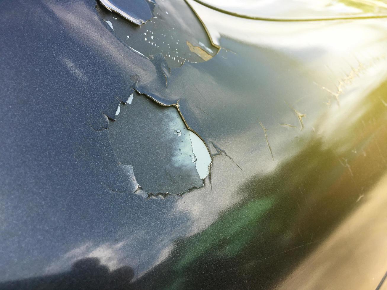 The paint sheet on the outside surface of the car is cracked into various shapes according to the condition and time of use of the car photo