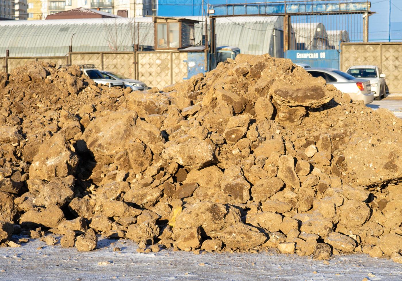 Blocks of frozen earth. A pile of earth.  The consequences of digging a hole with an excavator photo