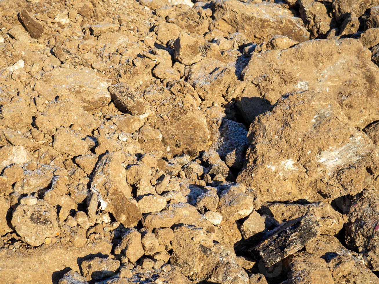 Blocks of frozen earth. A pile of earth. Cold weather. The consequences