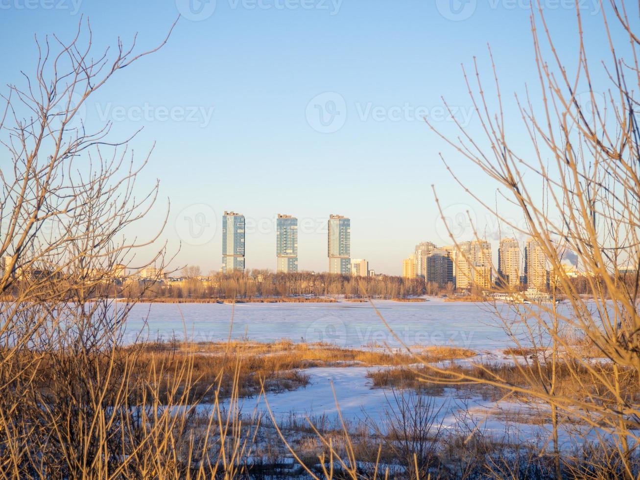Winter landscape. Sunset over the freezing river. photo
