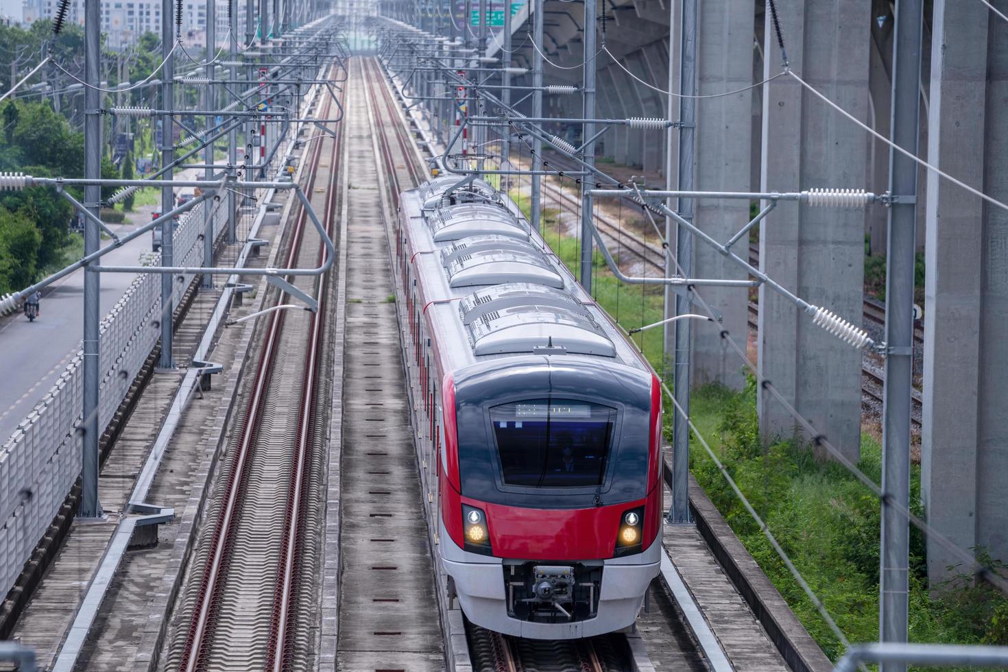 The electric train drives at high speed motion from the station with passenger and cargo to station destination is modern trasportation concept with sun light sky background. photo
