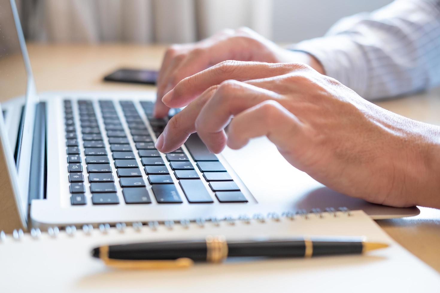 Selective focus at Asian men hand while type on computer keyboard and study online learning class at home. Social distance concept new normal lifestyle that people can work  or do home school. photo