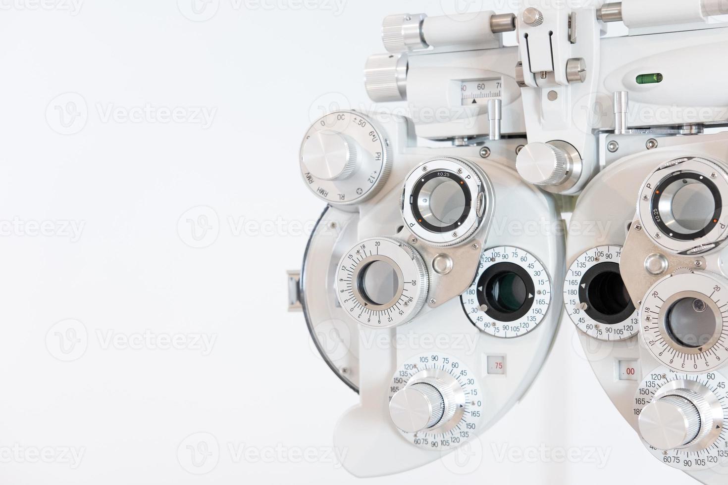 Selective focus at Optometry frame equipment. With blurred white background for copy space. Optometrist tool to examine eye visual system of patient with professional machine before made glasses. photo