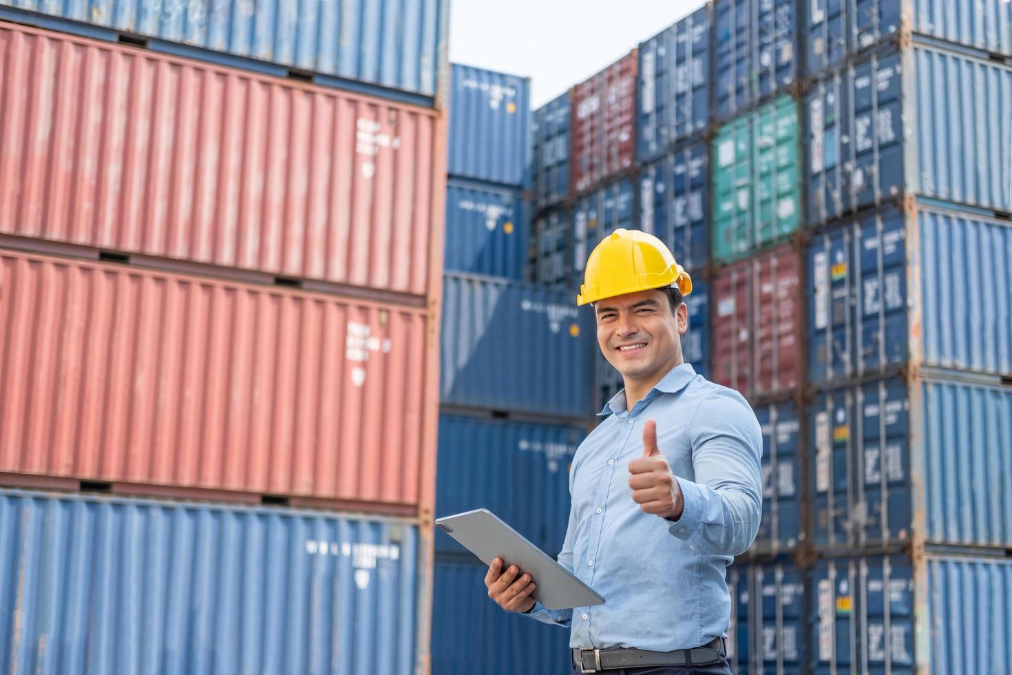 Caucasian men freight supervisor inspect the condition of all containers shipment by using tablet to record data and taking on smartphone. People and worker in freight deliver, import and export. photo