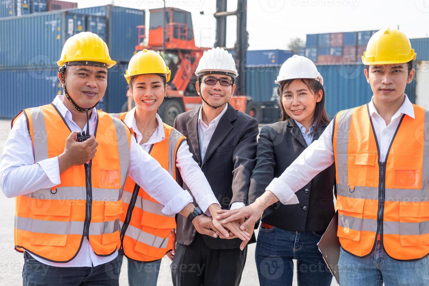 Asian people group of multi mix race worker with supervisor  holding hand to cheer up and encourage before working at industrial factory site. Teamwork, labor brainstorm or group working concept. photo