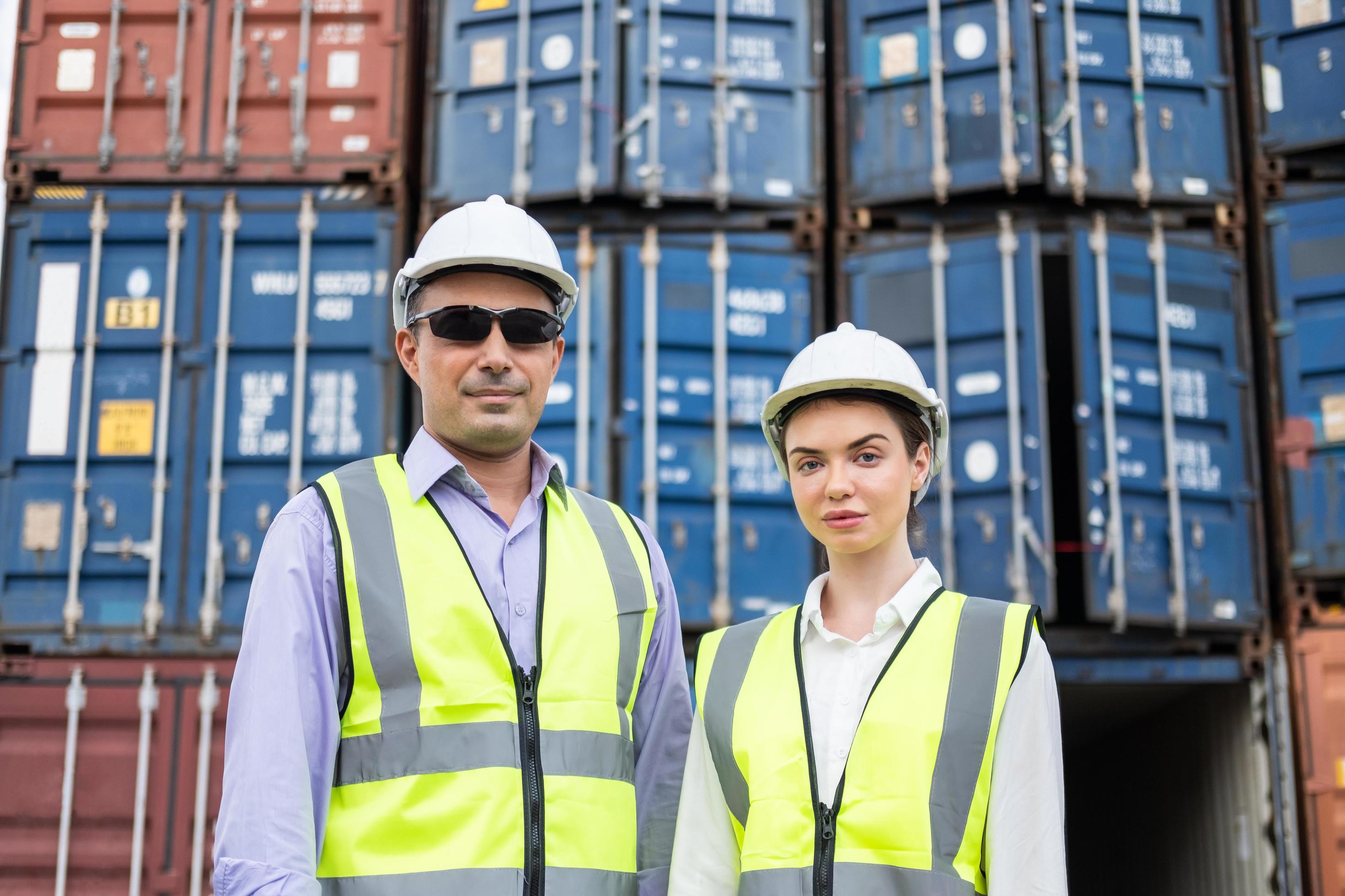 Caucasian men and women freight supervisor wearing safety vest and hat