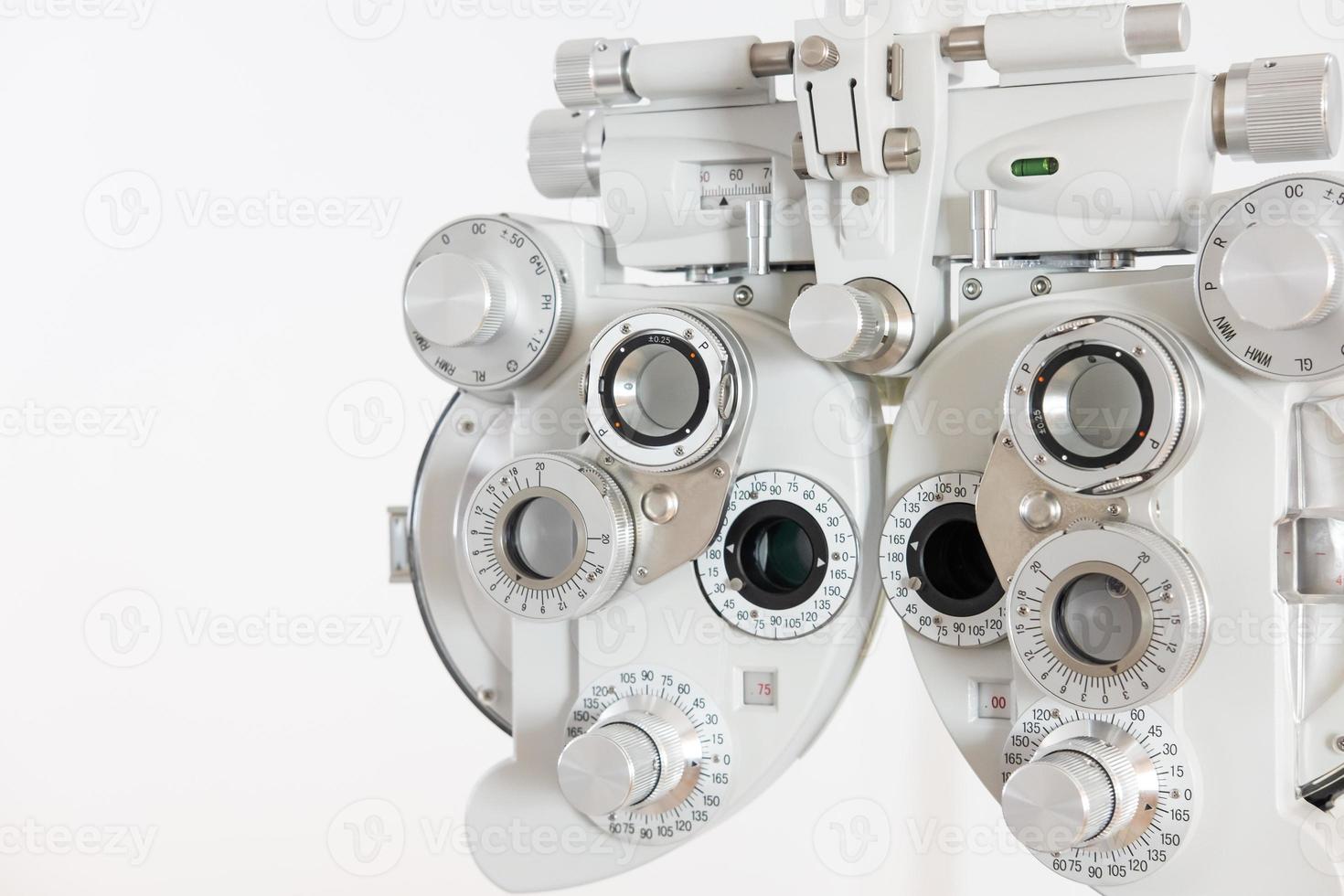 Selective focus at Optometry frame equipment. With blurred white background for copy space. Optometrist tool to examine eye visual system of patient with professional machine before made glasses. photo