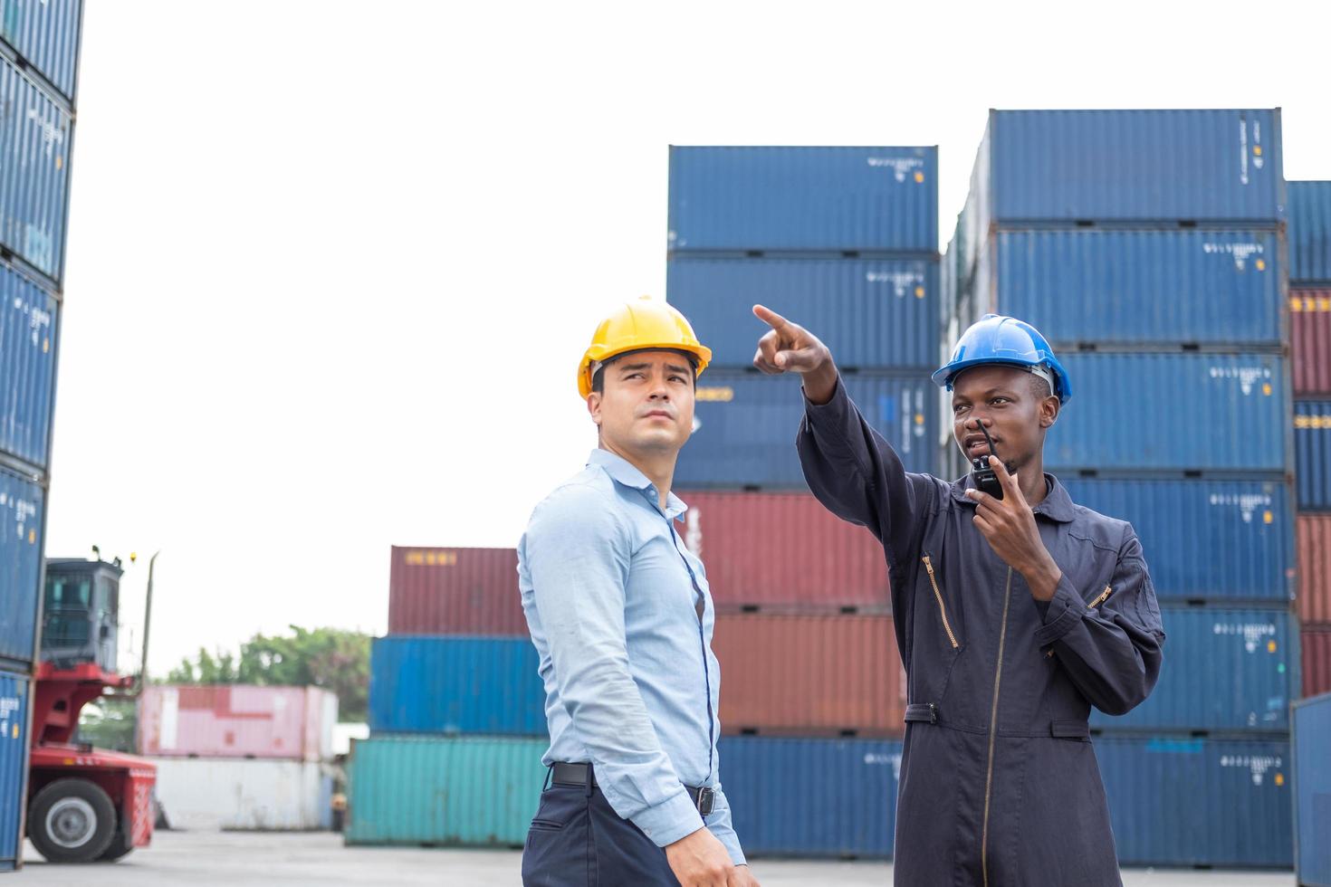 Selective focus at African black worker while talk and having discussion with supervisor and inspect the condition of all containers shipment, People and worker in freight deliver, import and export. photo