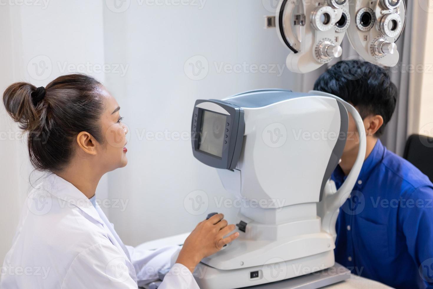 Selective focus at screen of Optometry equipment. While optometrist using subjective refraction to  examine eye visual system of elder patient women with professional machine before made glasses. photo