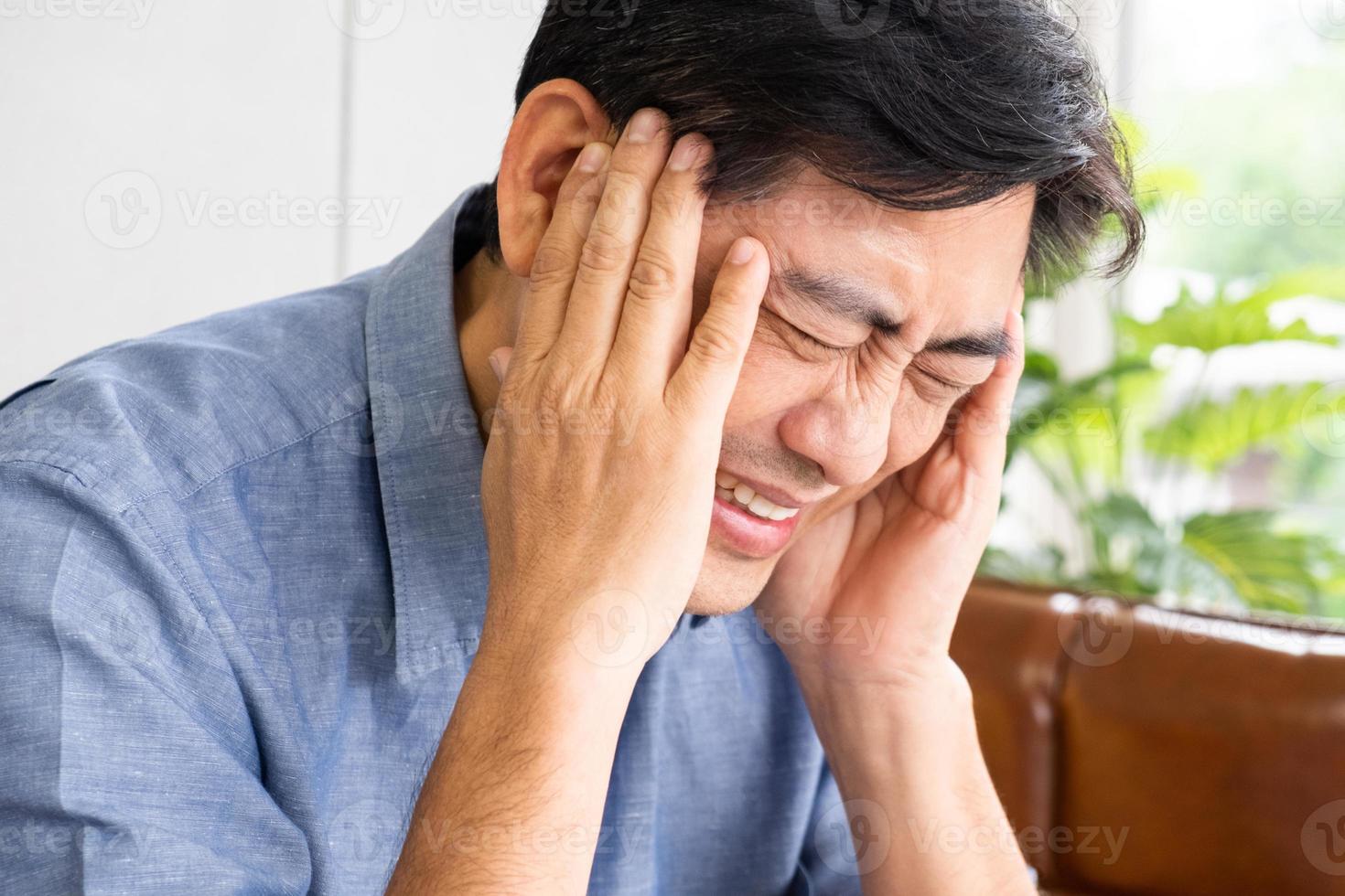 Close up shot of Asian male  senior suffering and pain from headache. Health problem or stress in elder people. Healthcare and medical concept. photo