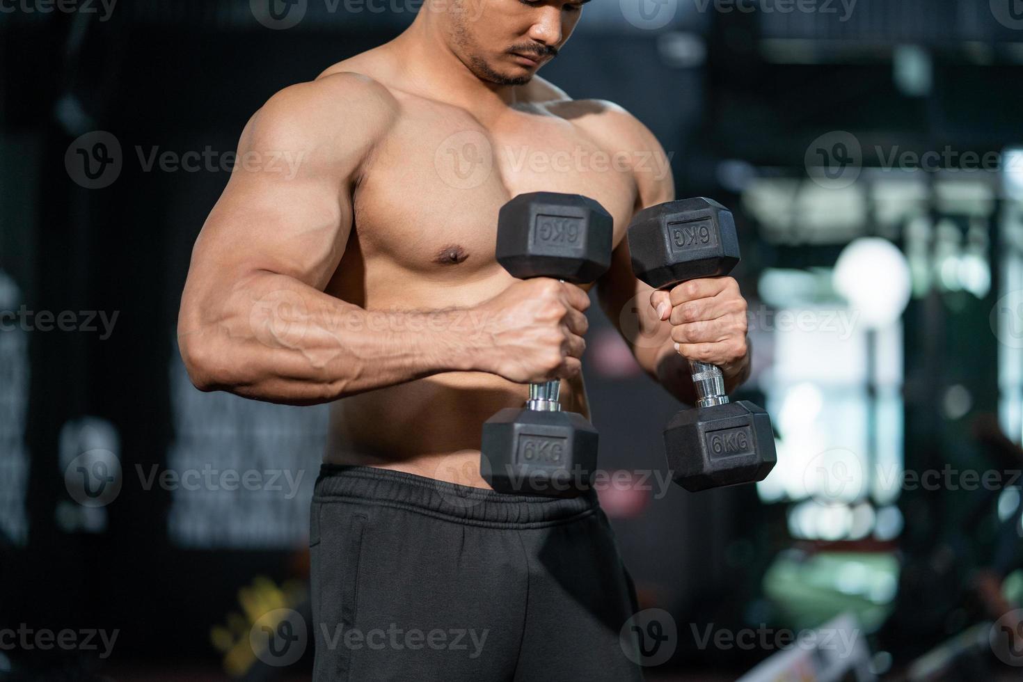 Handsome adult Caucasian men sweating while lift up the dumbbell workout for arm biceps muscle part inside of fitness gym. Bodybuilding athlete sport training for body strength and good health. photo