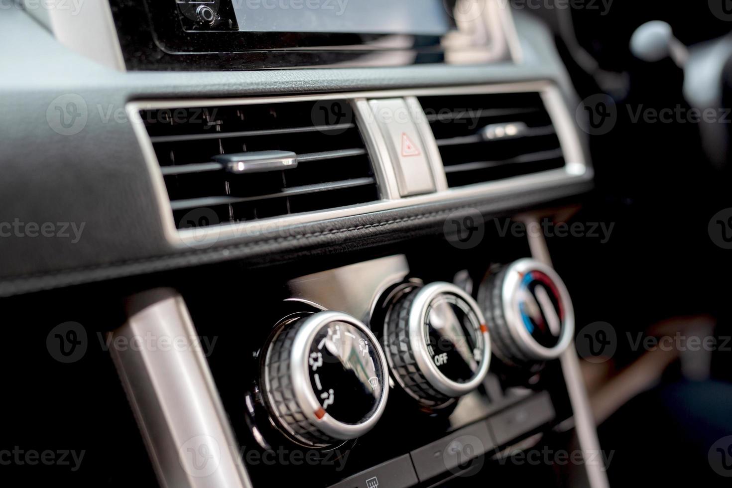 Salesperson adjusts the car air conditioner photo