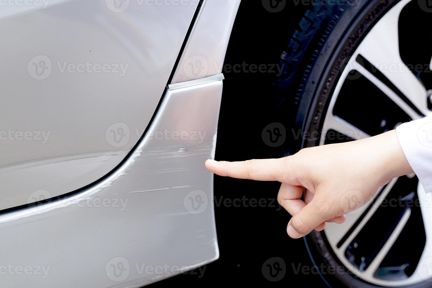 Scratched car paint with door handle and tire photo