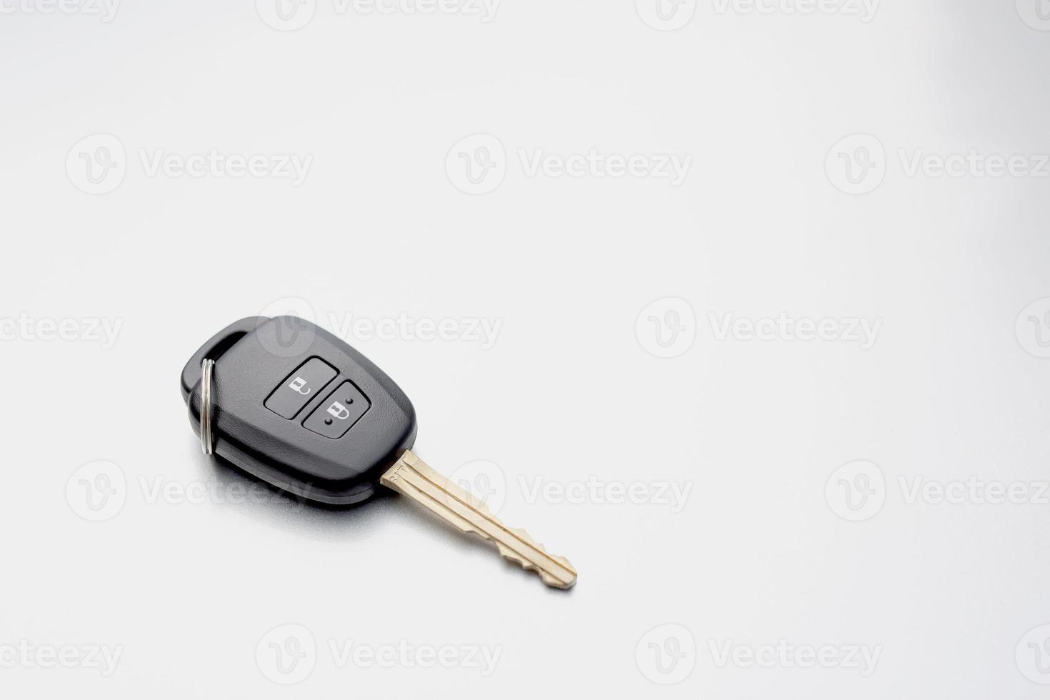 Car keys in front of the car at the showroom. photo