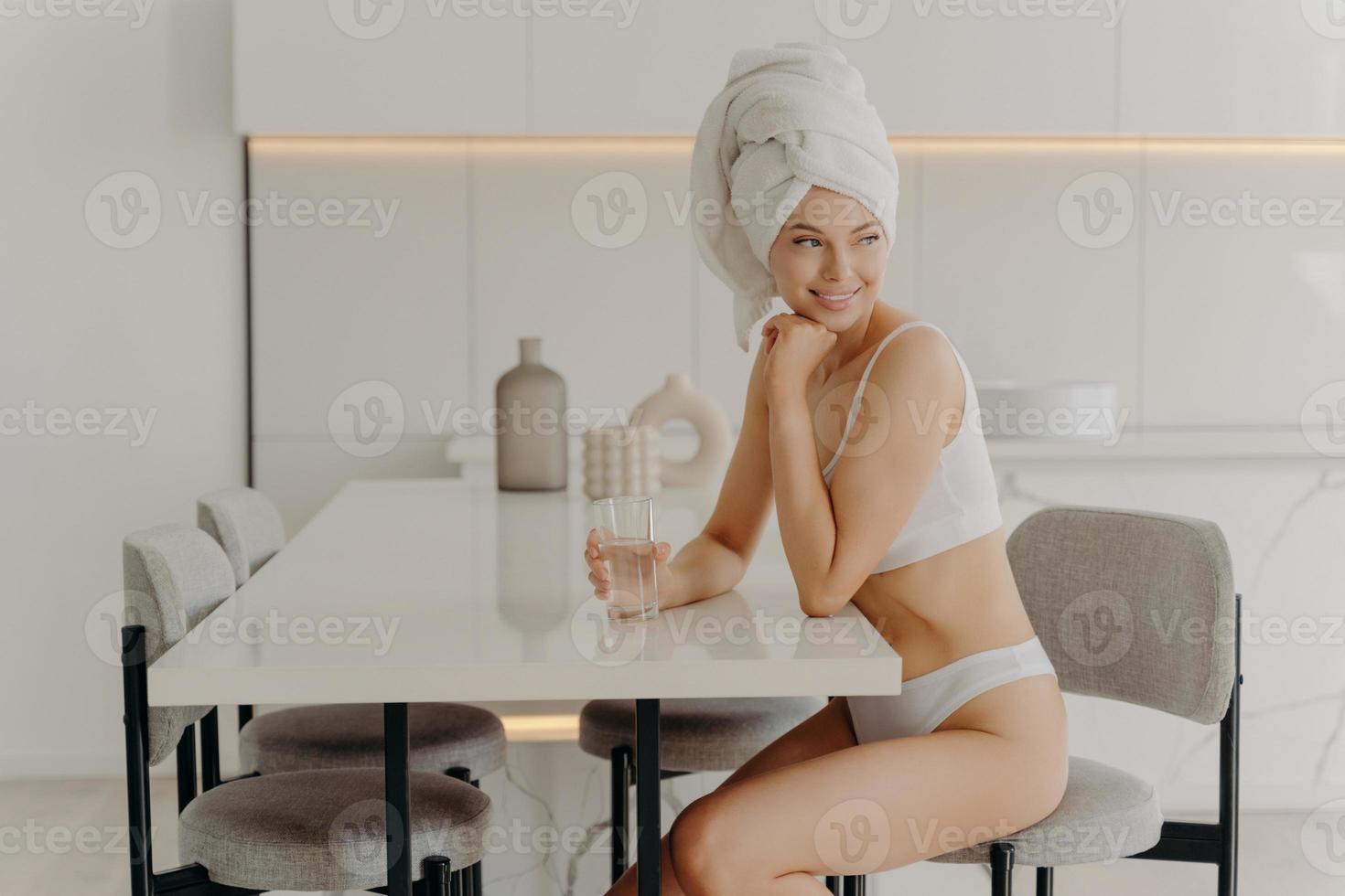 https://static.vecteezy.com/system/resources/previews/013/001/561/non_2x/young-pretty-european-woman-in-white-underwear-drinking-water-in-kitchen-in-morning-photo.JPG