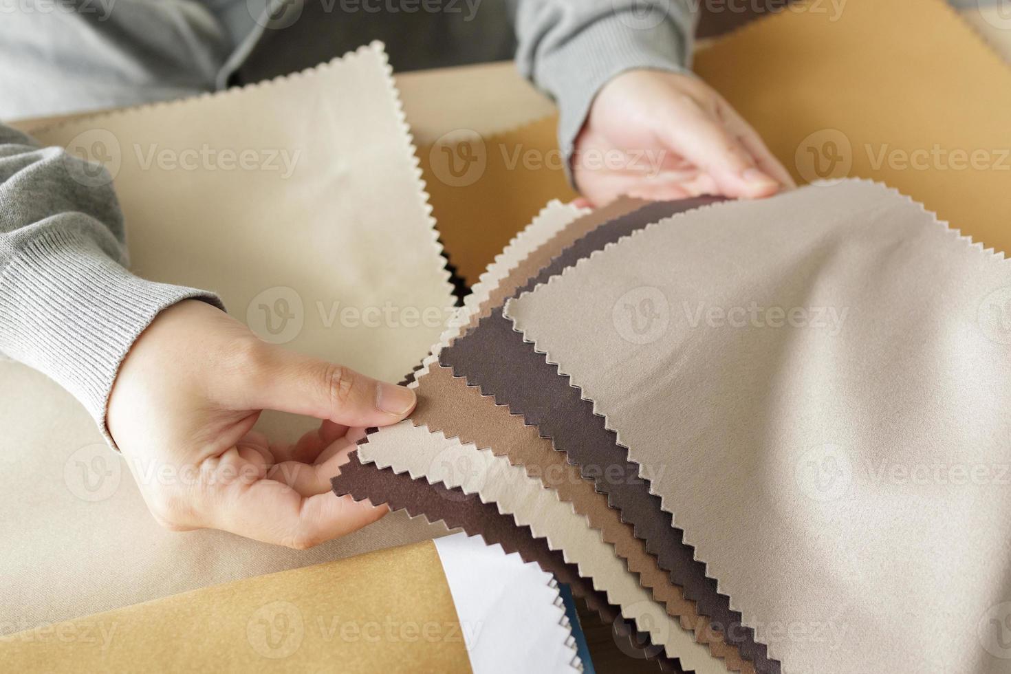 female designer with fabric color samples choosing textile for curtains photo