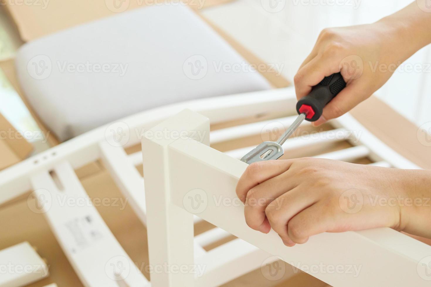 Assembly furniture using screwdriver at home photo