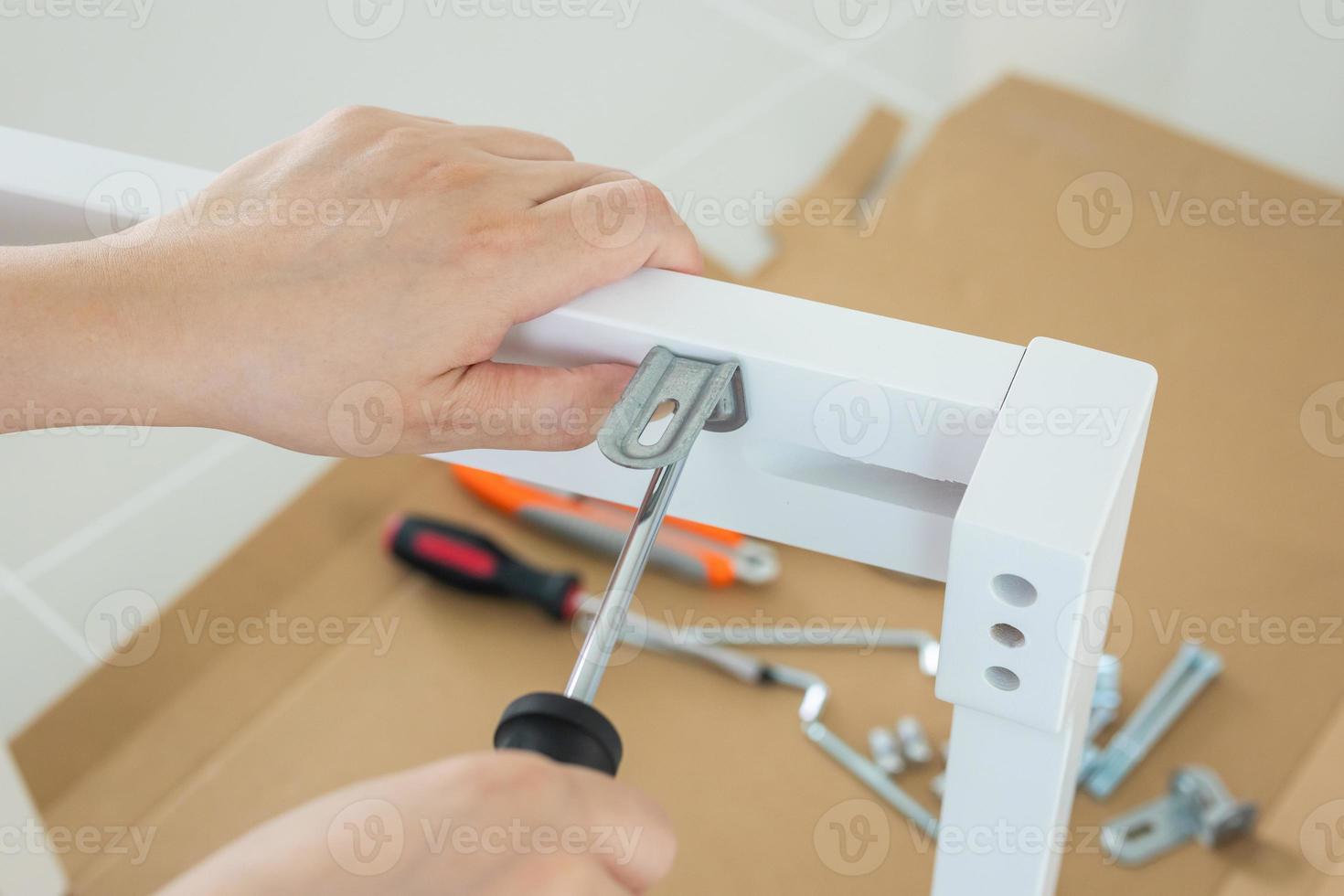 Assembly furniture using screwdriver at home photo