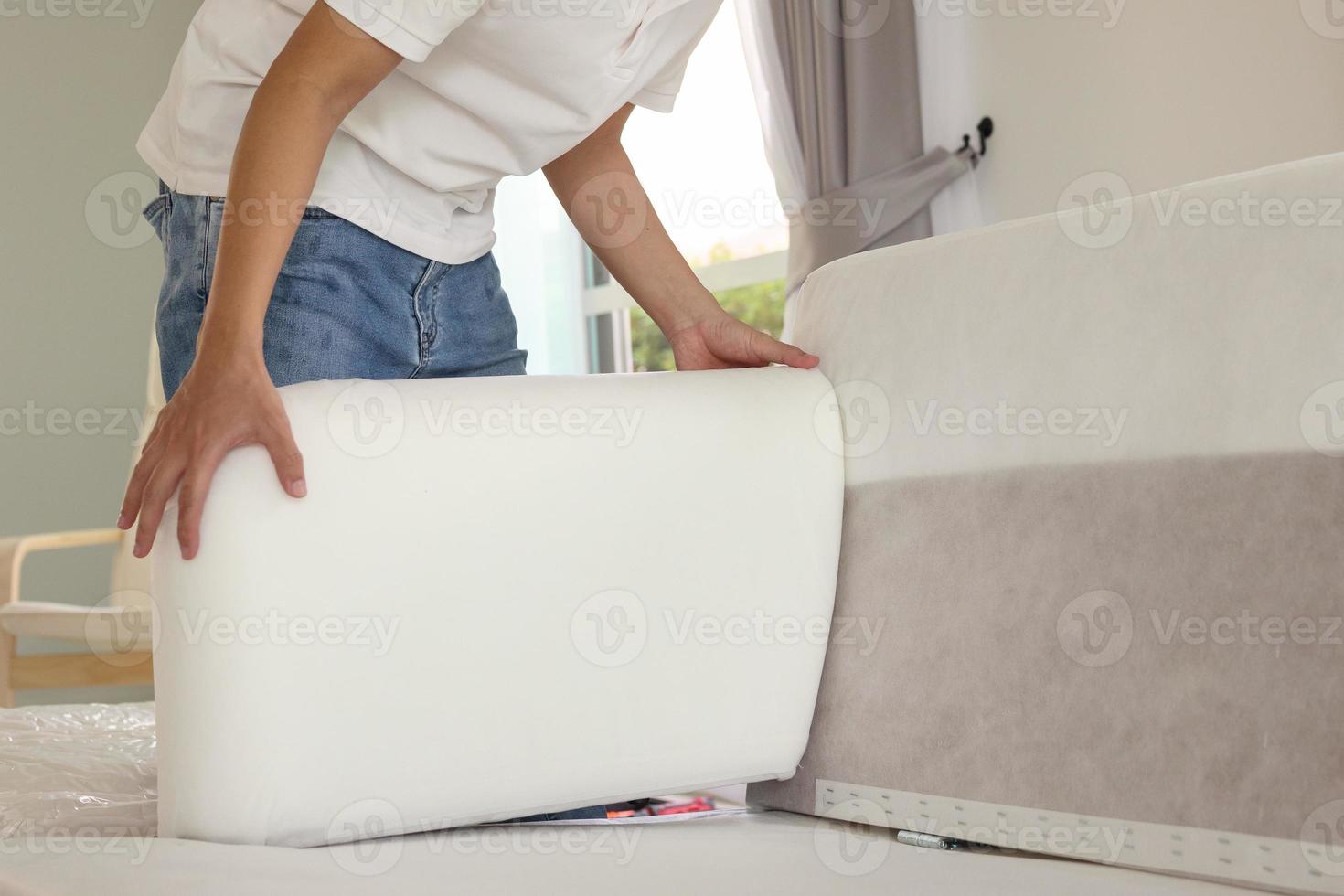 Man assembling sofa furniture at home photo