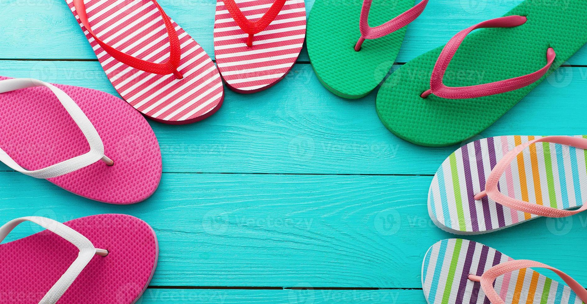 flip flops on blue wooden floor background. Top view and copy space. Summer fun weekend. Banner mock up. photo