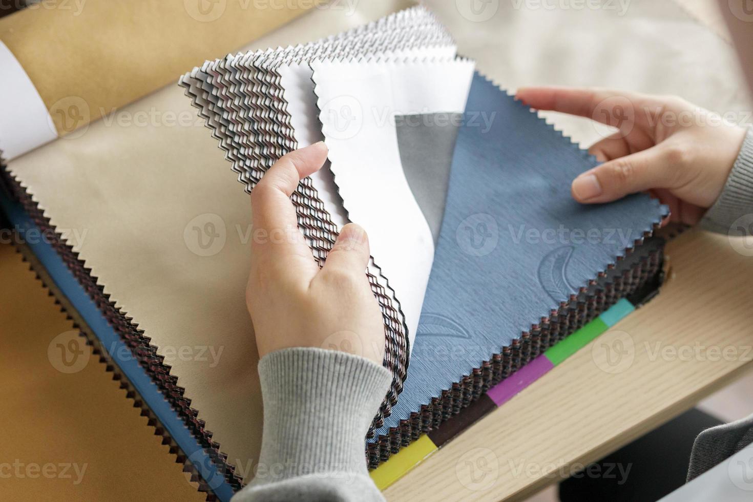 female designer with fabric color samples choosing textile for curtains photo