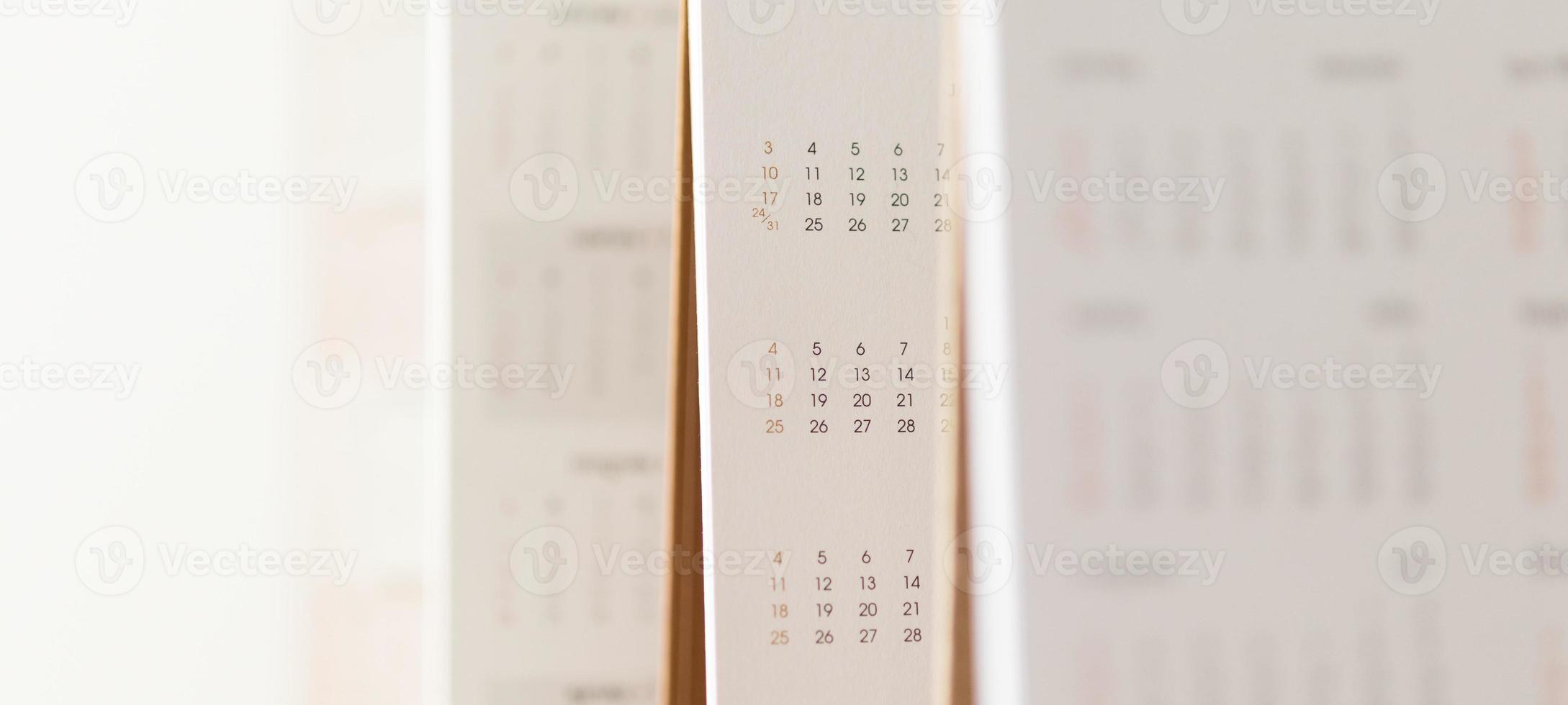 Close up calendar page dates and month background business planning appointment meeting concept photo