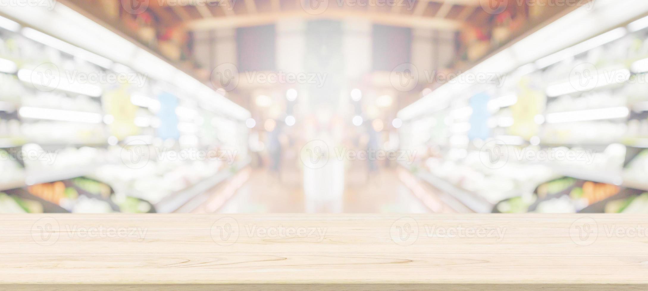 Wood table top with supermarket grocery store blurred background with bokeh light for product display photo