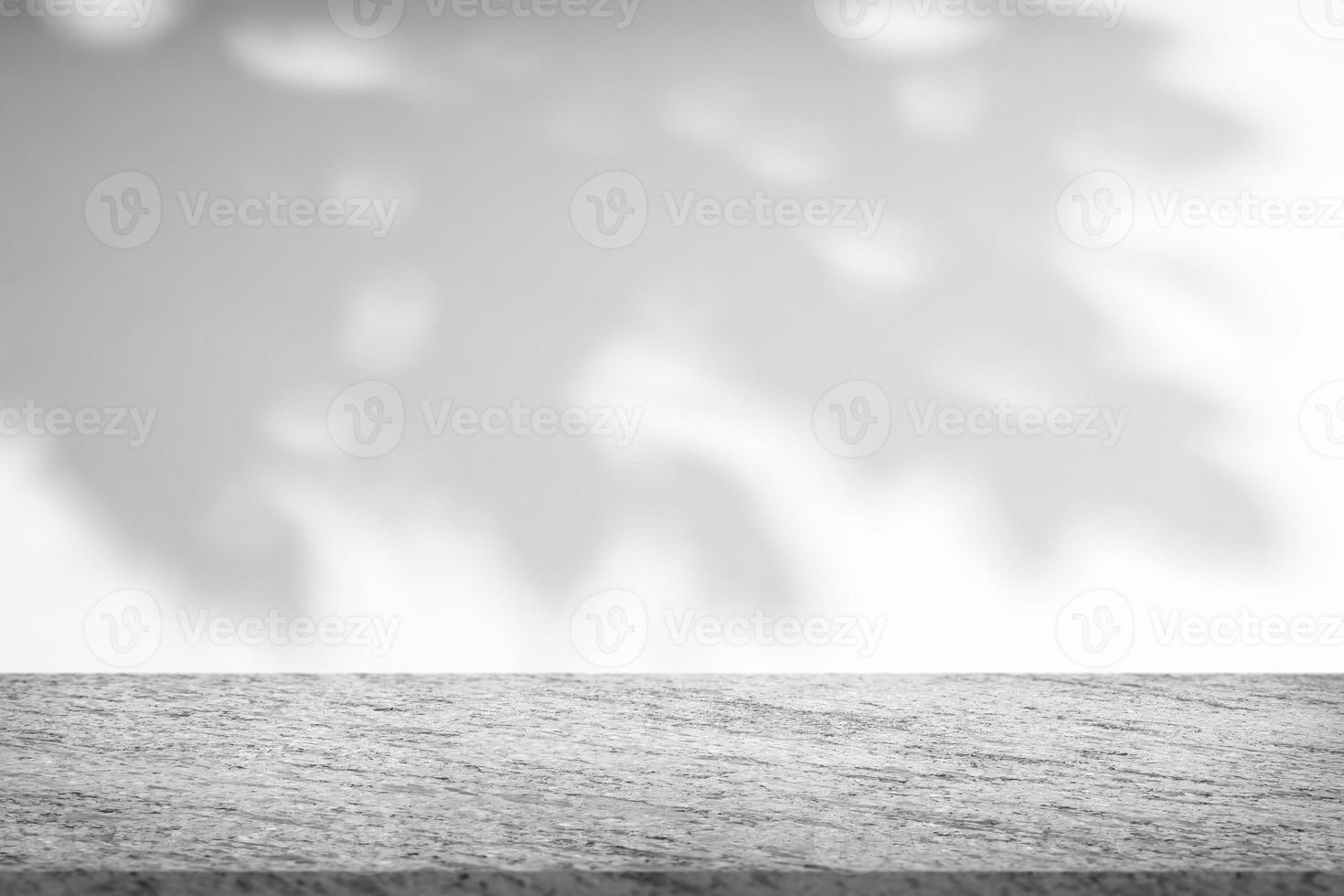Marble table with tree shadow drop on white wall background for mockup product display photo