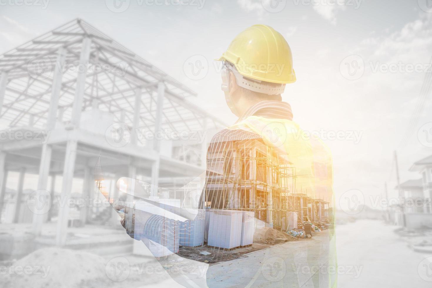 Double exposure image of professional engineer in protective helmet and blueprints paper at the house building construction site photo