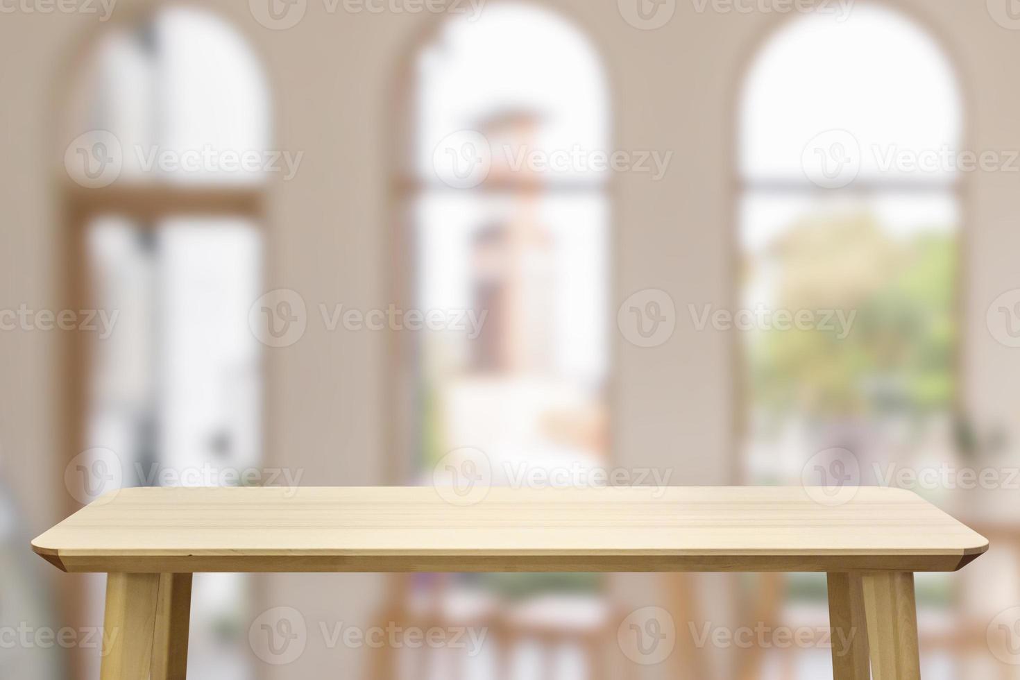 Empty wood table top with cafe restaurant interior blur background photo