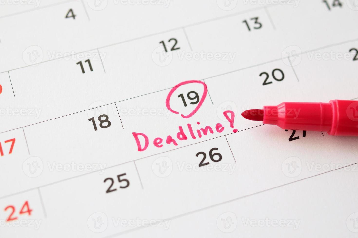 Deadline write on white calendar page date close up photo