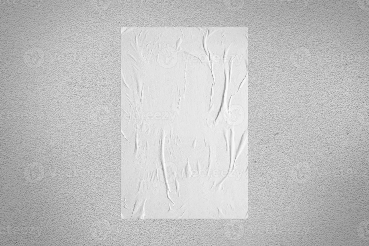 Blank white wheatpaste glued paper poster mockup on concrete wall background photo
