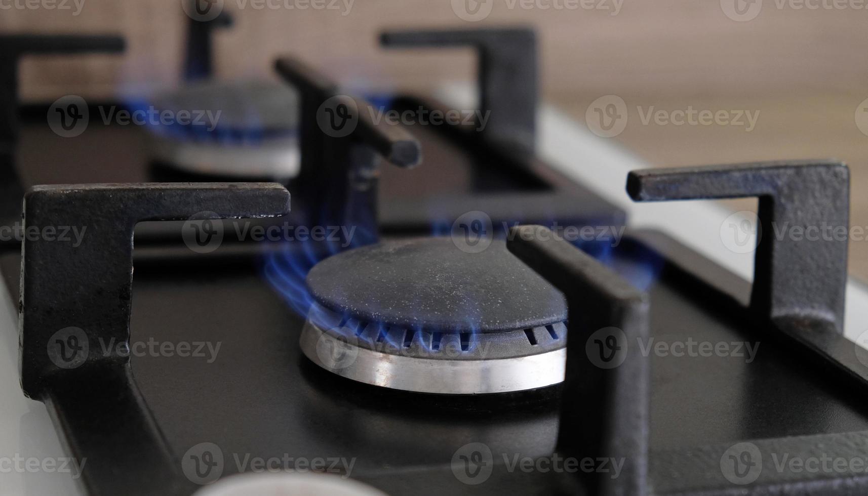 Close-up blue flames of fire on a gas burner in the kitchen for cooking. Gas flame in a gas boiler photo