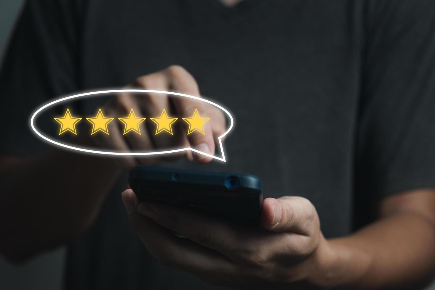 businessman hand using smart phone and give five star symbol icon for feedback review satisfaction service rating of product. Satisfaction Concept. photo